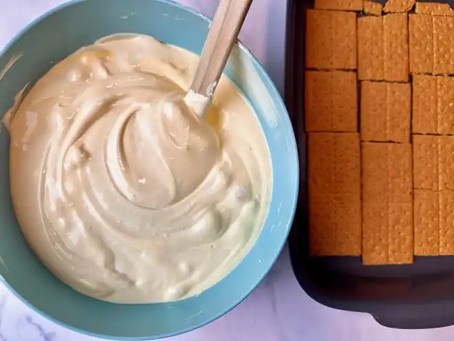 To make chocolate eclair cake filling, fold frozen whipped topping into vanilla pudding.