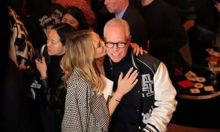 Tommy Hilfiger is kissed by his wife