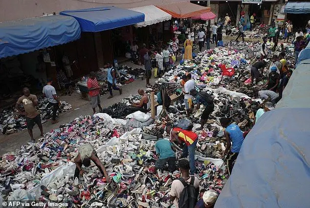 Traders spread out secondhand clothes for sale at the Kantamanto market in Accra, Ghana. Kantamanto market is vast, spanning over 20 acres in the heart of Accra's business district, and its stalls are dominated by used clothing and shoes from the West and China