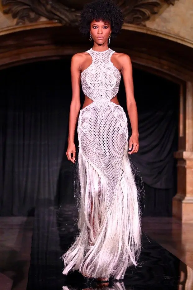 NEW YORK, NEW YORK - FEBRUARY 10: A model wears a long white racer-back dress with laticework cutout detail and an elongated fringed hem at the PatBo runway show at Surrogate's Court during New York Fashion Week on February 10, 2024 in New York City. (Photo by Shannon Finney/Getty Images for NYFW: The Shows)