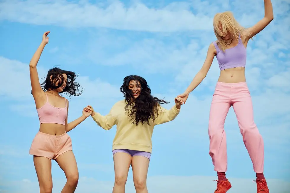 a group of women in pink and purple clothes