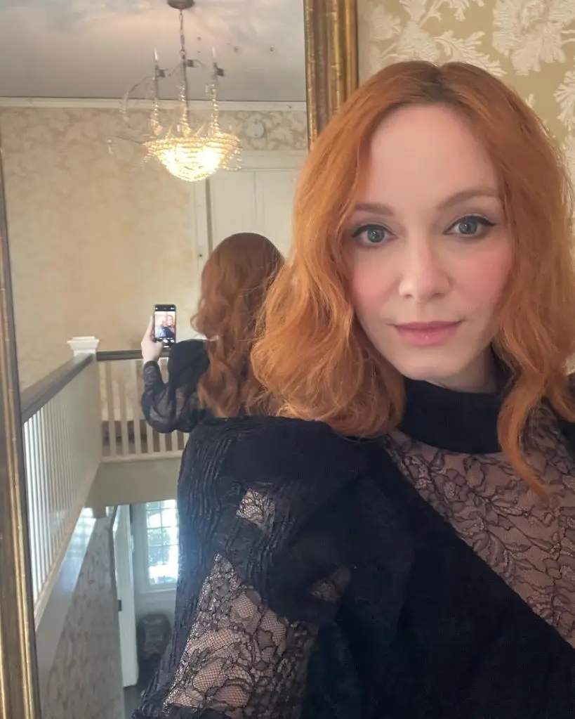 christina hendricks wearing black lace mini dress inside home