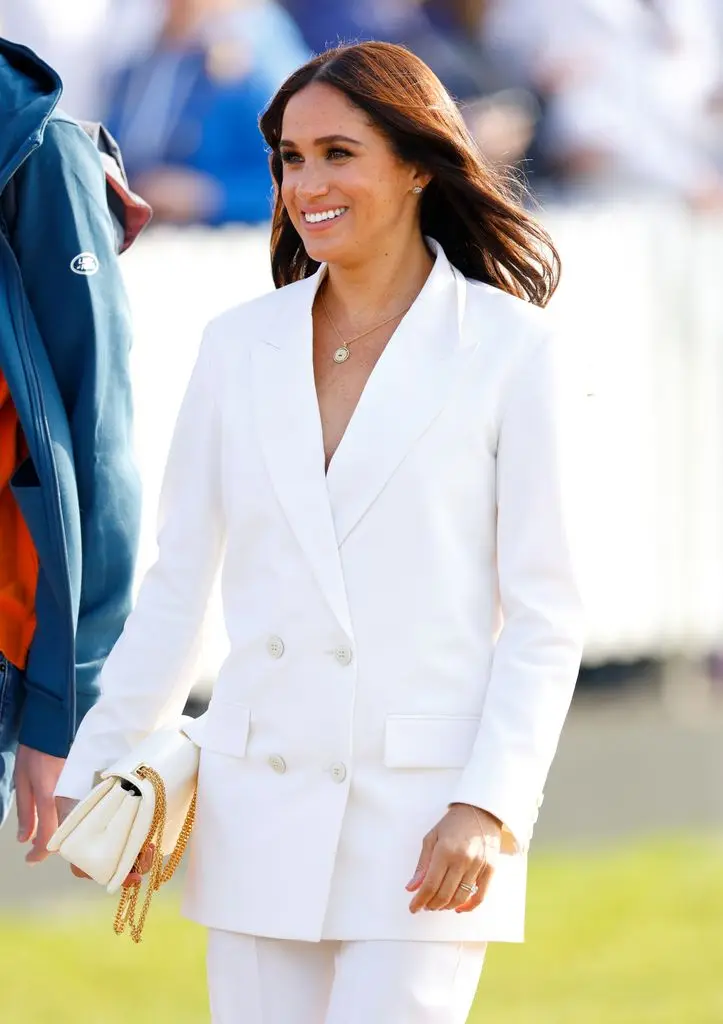 Meghan in white blazer look smiling