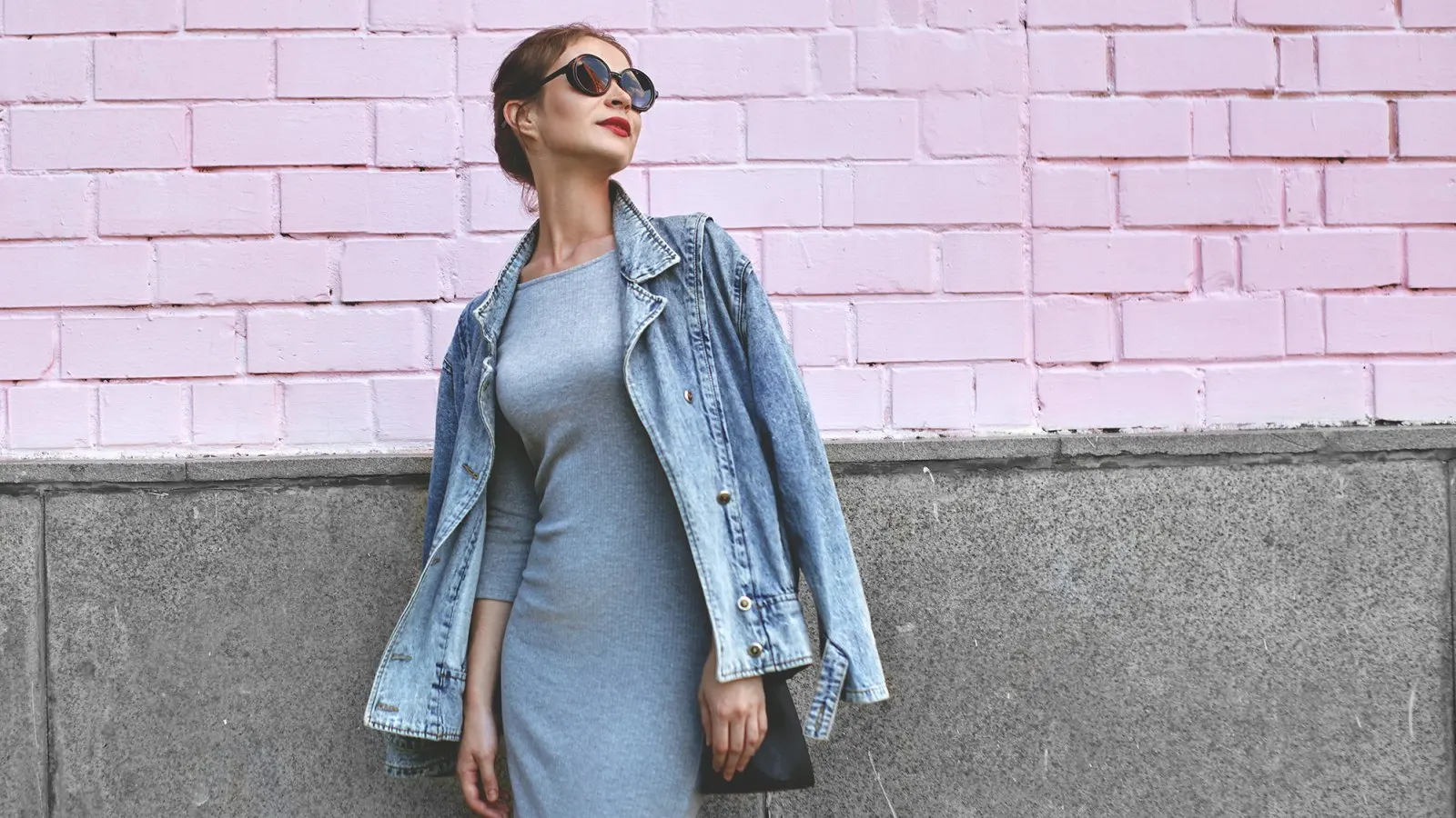 Street Style Shoot of Woman on Pink Wall. Swag Girl Wearing Jeans Jacket, grey Dress, Sunglass. Fashion Lifestyle Outdoor