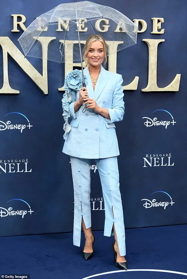 Elsewhere on the carpet, Laura Whitmore, 38, stunned in a pale blue suit with a ruffled bow motif