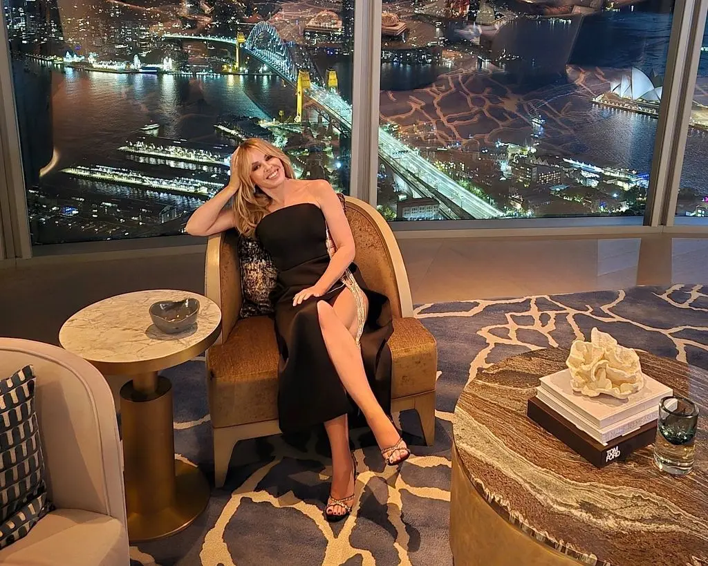 A photo of Kylie Minogue sitting on a chair