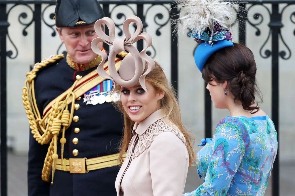 Princess Beatrice of York in a nude dress and fascinator at Prince William's royal wedding