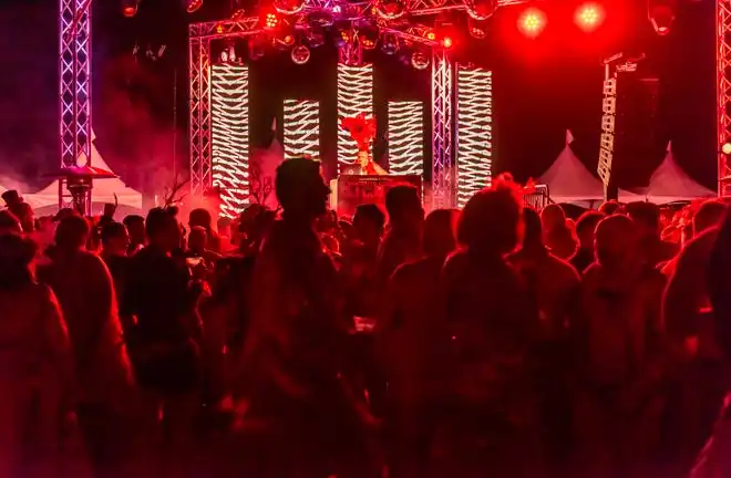 Guests hit the dance floor at the LGBTQ Community Center of the Desert's Red Dress/Dress Red Party in Palm Springs, Calif., on March 16, 2024.