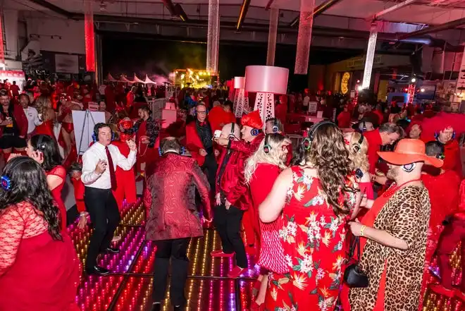 Guests enjoy the silent disco at the LGBTQ Community Center of the Desert's Red Dress/Dress Red Party in Palm Springs, Calif., on March 16, 2024.