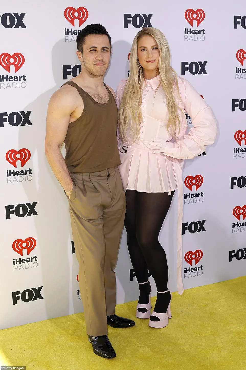 She also struck a pose with Chris Olsen, who showed off his muscles in a brown tank top