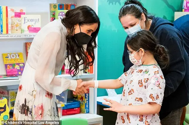 The Duchess of Sussex, 42, styled her sleek brunette tresses loose and opted for a natural makeup look