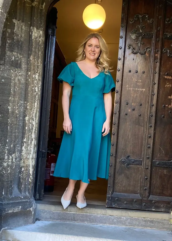 Kate posing in teal wedding dress Modify by Modiste