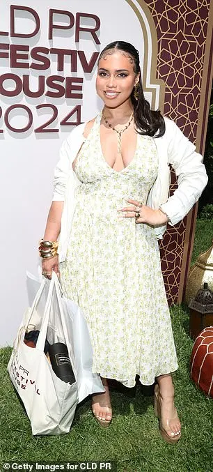 Asia Monet looked ready for spring in a plunging floral gown which she teamed with a white cardigan