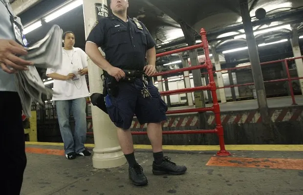 NEW YORK - JULY 11: An NYPD officer keeps watch inside Times Square subway station July 11, 2006 in New York City. Police raised security on subways in the city following the bombings of trains in India that killed at least 147 people. (Photo by Mario Tama/Getty Images)