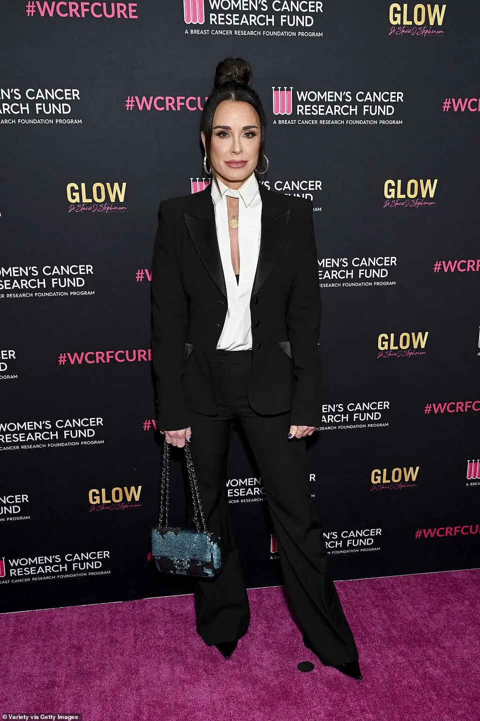 Her former co-star Kyle Richards, 55, was also in attendance, and opted for a classic black pantsuit with a cream shirt underneath