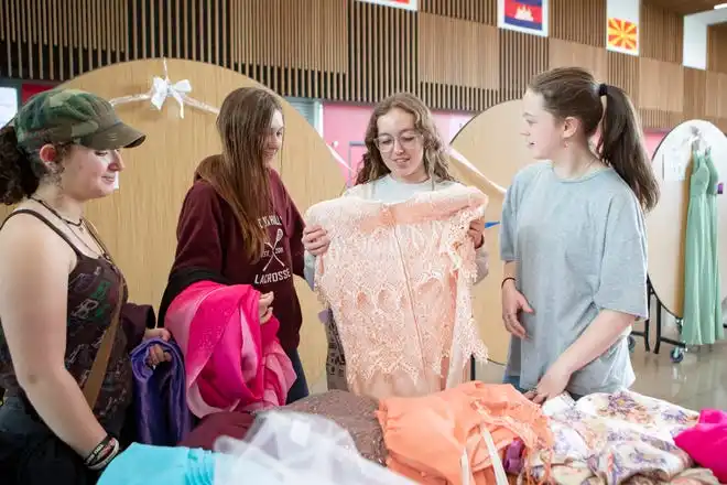 Students look through prom dresses Friday during a giveaway at North Eugene High School.