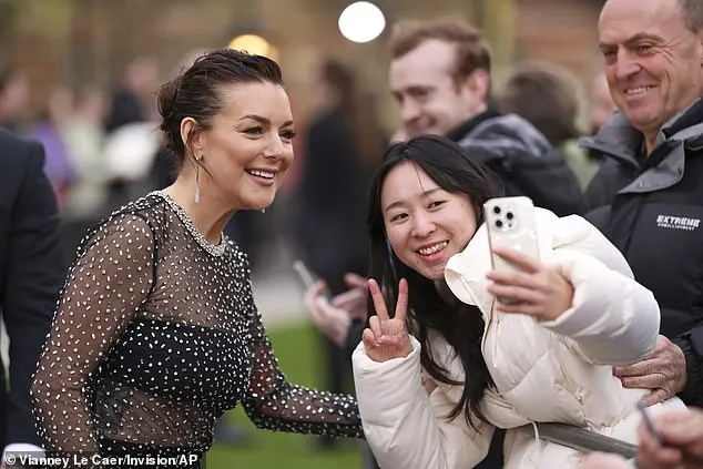 Stage and screen star Sheridan stopped to greet fans and have her picture taken with them on arrival