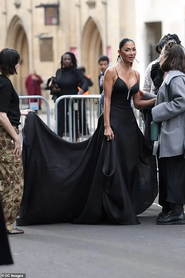 Nicole flashed her long toned legs and a serious amount of sideboob in the revealing dress, which was also cinched at her tiny waist