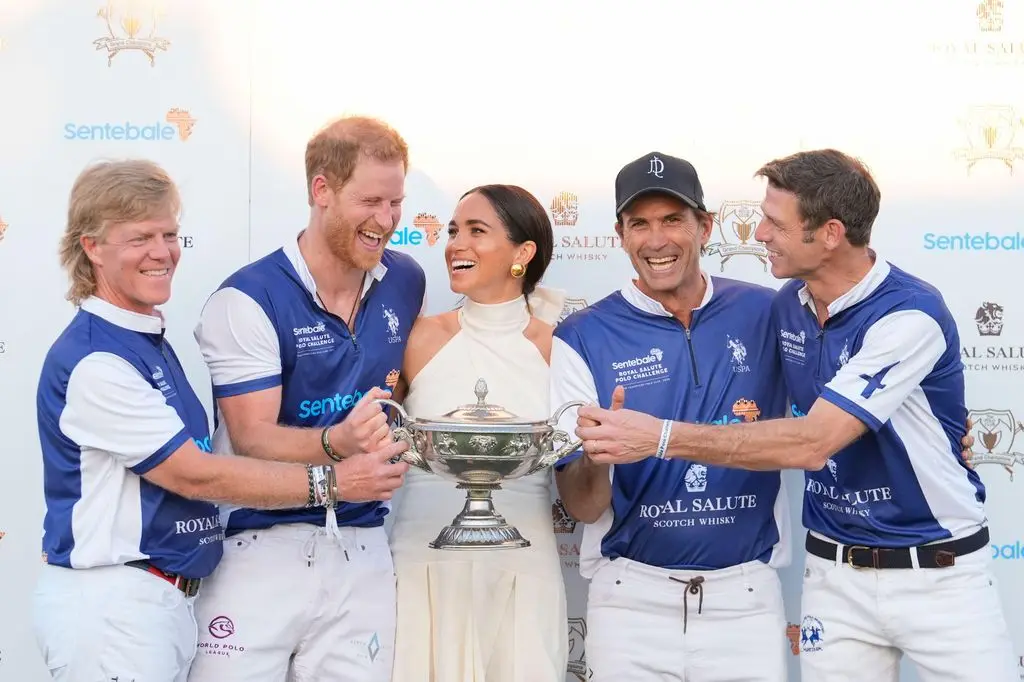 The couple laugh together as Meghan presents him and his polo teammates with the trophy for winning the 2024 Royal Salute Polo Challenge to Benefit Sentebale