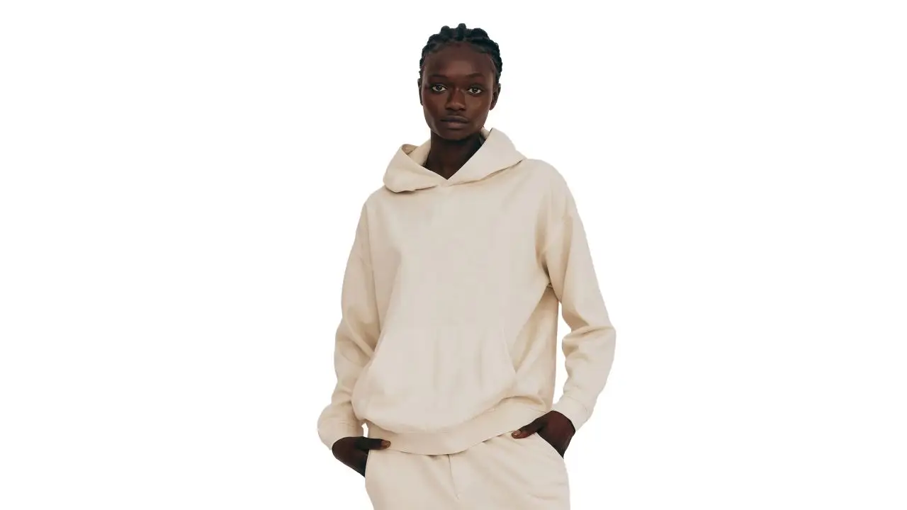 Woman wearing lounge hoodie in cream color