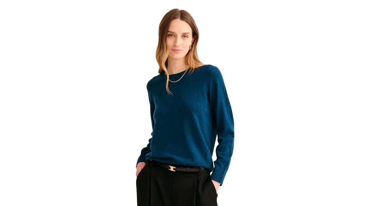 Woman wearing peacock blue cashmere sweater from Naadam