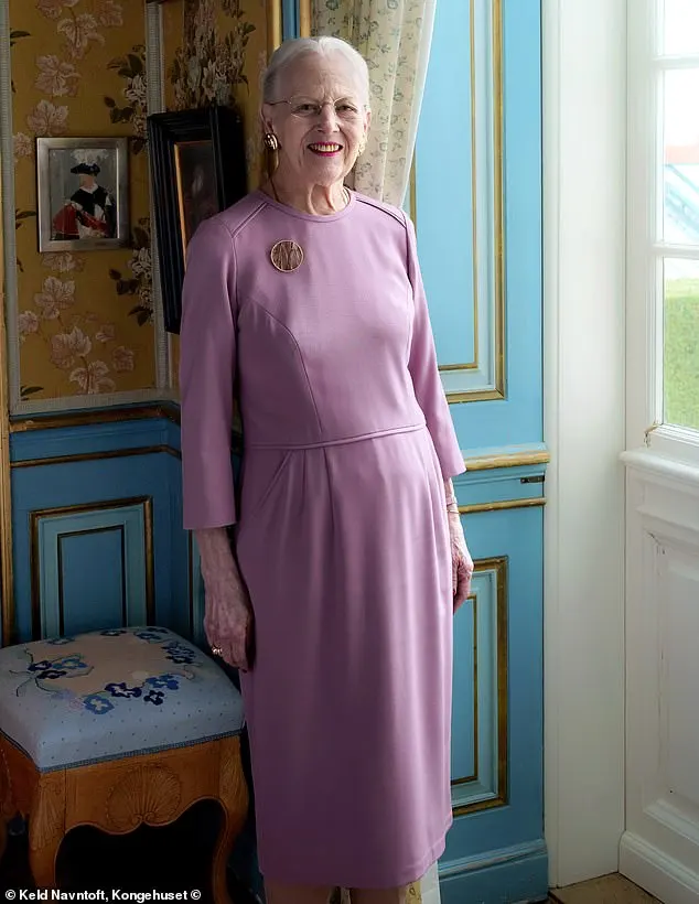 Queen Margrethe poses in one of the rooms at Fredensborg Castle, as she leans against beautifully decorated teal walls