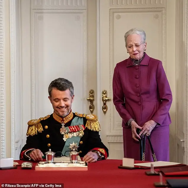 The former monarch looks on as her son, King Frederik, signs the declaration on January 14