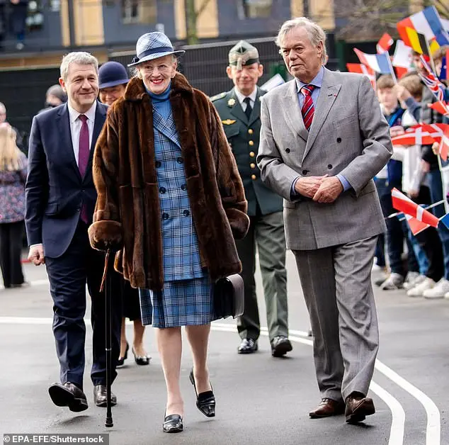 Queen Margrethe is pictured smiling as crowds gather to watch her journey to inaugurate the new Prins Henriks Skole