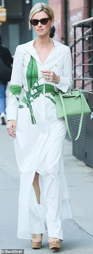 Nicky carried a matching clean Hermes purse while the long-sleeve whitened dress had a vibrant flower display.