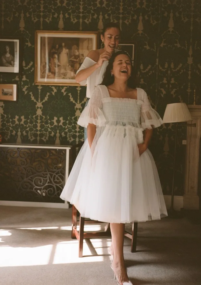 Make-up artist Celia Burton, in her Molly Goddard dress, has her veil fitted