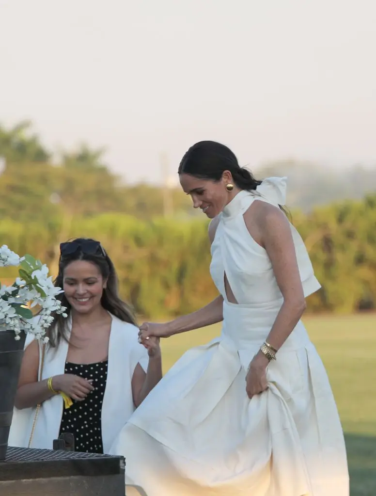 Meghan Markle at the Royal Salute Polo Challenge wearing a white backless number, complete with bow