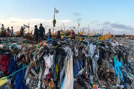 Fashion and plastic waste choke a fish landing in Accra, Ghana.