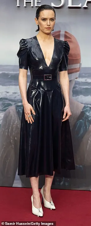 Complete with puffed shoulder pads, Daisy cinched in her waist with a matching black leather belt and accessorised the look with some cream leather heels