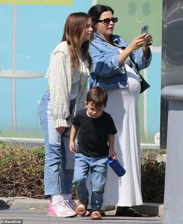 The actress, 43, who is expecting her second baby with fiancé Steve Kazee and third child overall - looked incredible as she teamed a light blue denim jacket with the stylish ensemble