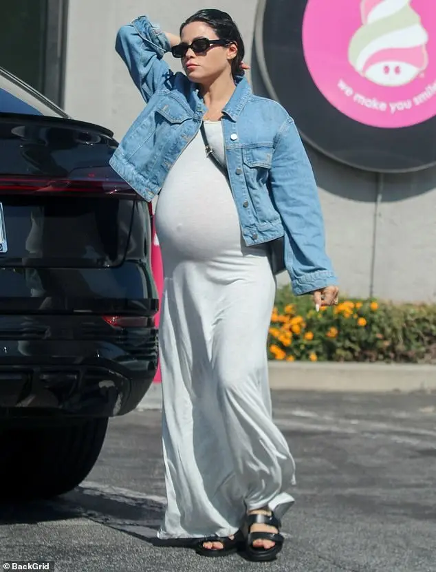 She opted for toting her essentials around in a black cross-body bag and further accessorised with a pair of black oval shades