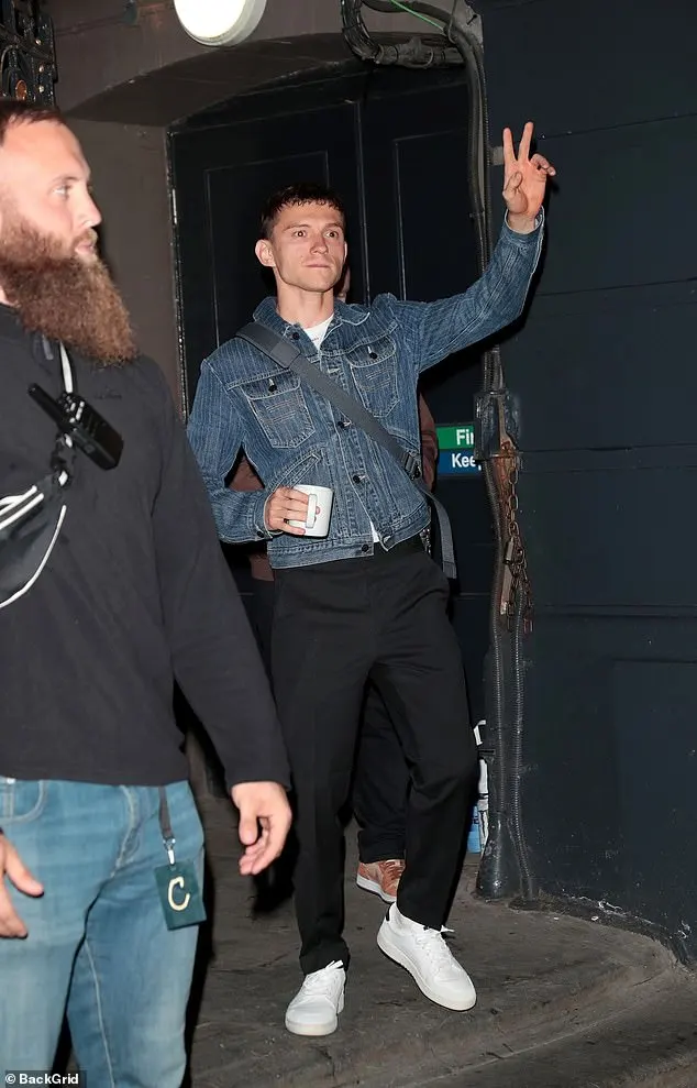 All eyes were on the main man Tom as he emerged with his arms up in the air as he waved to crowds while clutching a cup of tea in hand