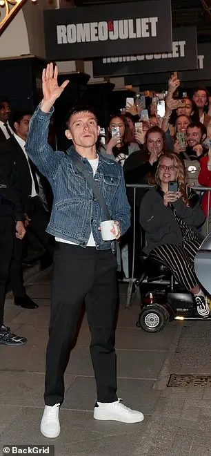Swapping his Hollywood look for a Hackney-inspired ensemble. he wore a buttoned up denim jacket with jeans and a man bag worn crossbody