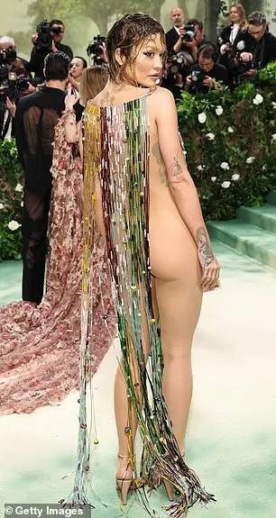 Her sheer ensemble put her large collection of unique tattoos on full display as her quirky garment barely covered the star's assets