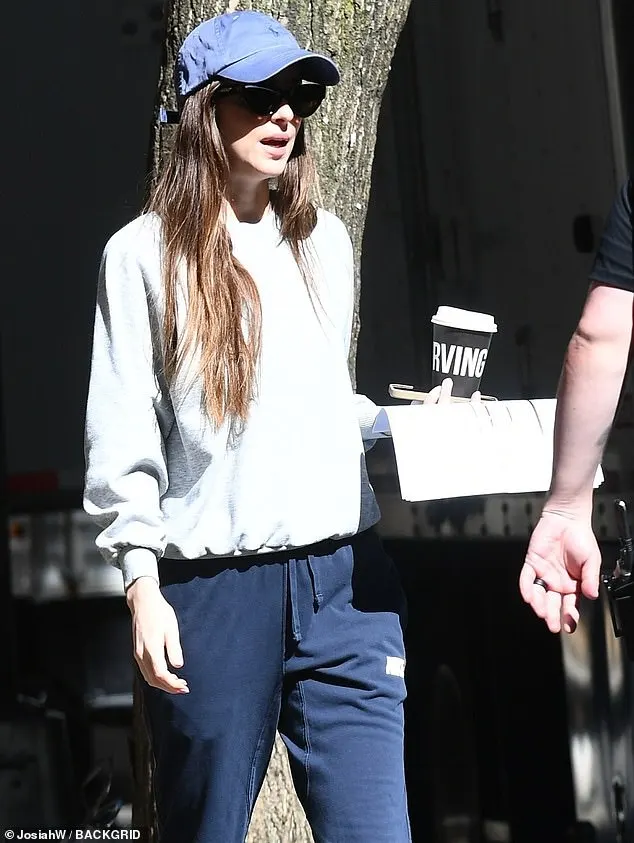 Dakota added a blue baseball cap then stepped out into the sun, ready for some filming