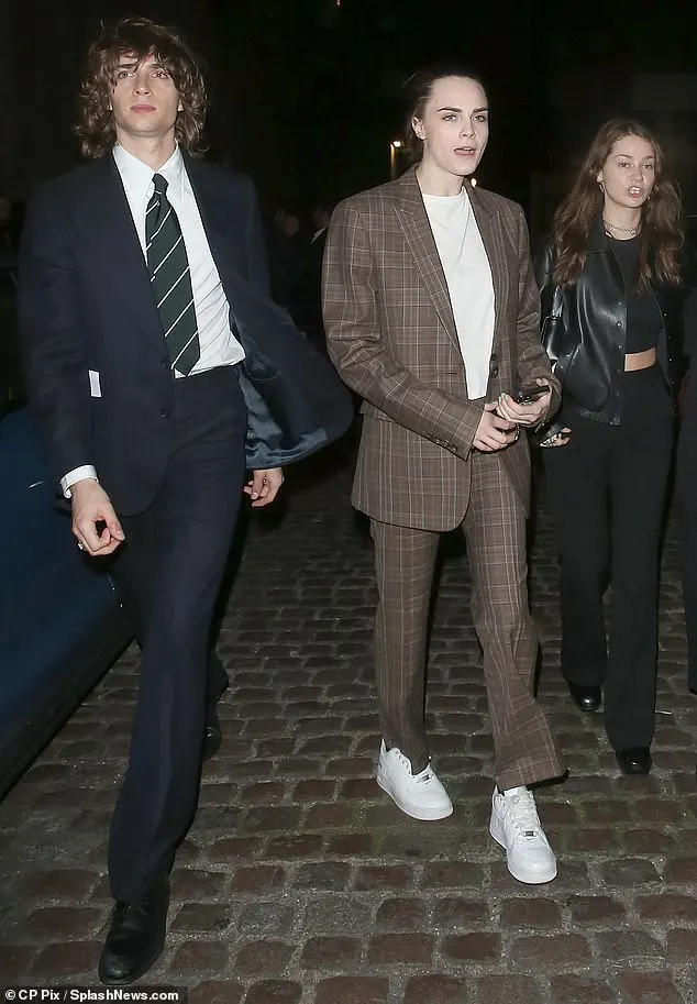 Anya's husband Malcolm McRae (left) looked dapper in a sharp suite and a striped tie