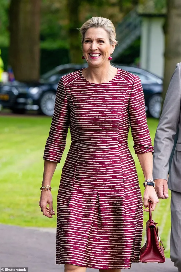 The smiling royal, 53, added a touch of glamour with a pair of red spherical earrings and gold bracelets