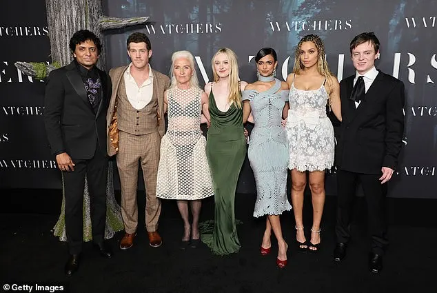 The actress posed center in green alongside the film's director, producer, and costars at the red carpet premiere of The Watchers in New York City on Sunday