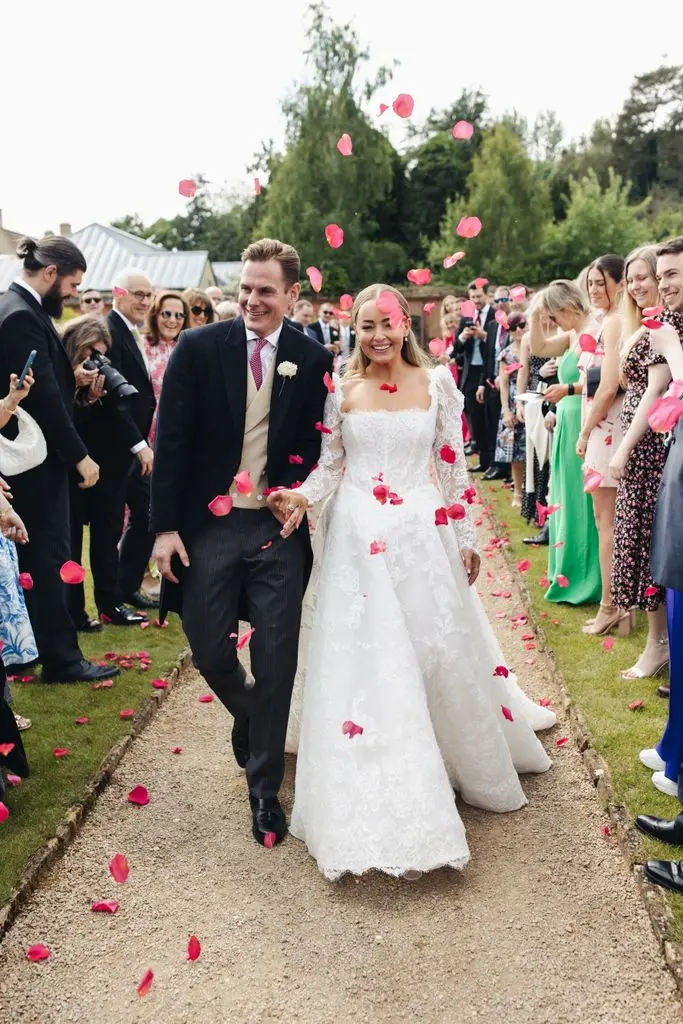 Alice Liveing walking through confetti on her wedding day