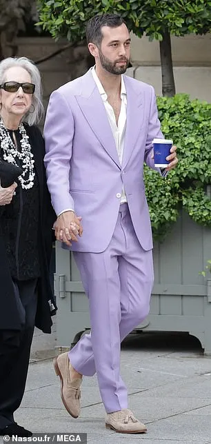 The blonde beauty donned a strapless white mini dress for the outing, while her partner Alexander (seen) opted for a lavender suit