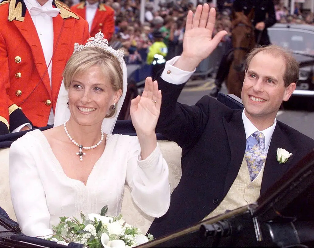 Duchess Sophie and Prince Edward waving from a carriage on their wedding day