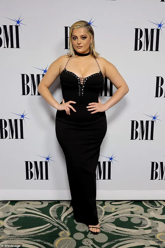 The hitmaker, 34, hit the red carpet in a busty black dress that showed off her hourglass curves