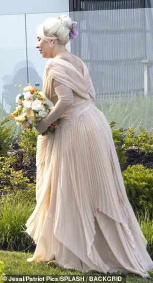 The Just Dance hitmaker, 38, whose real name is Stefani Germanotta, wowed in a peach-coloured bridesmaid dress and matching sheer gloves while holding onto yellow flowers