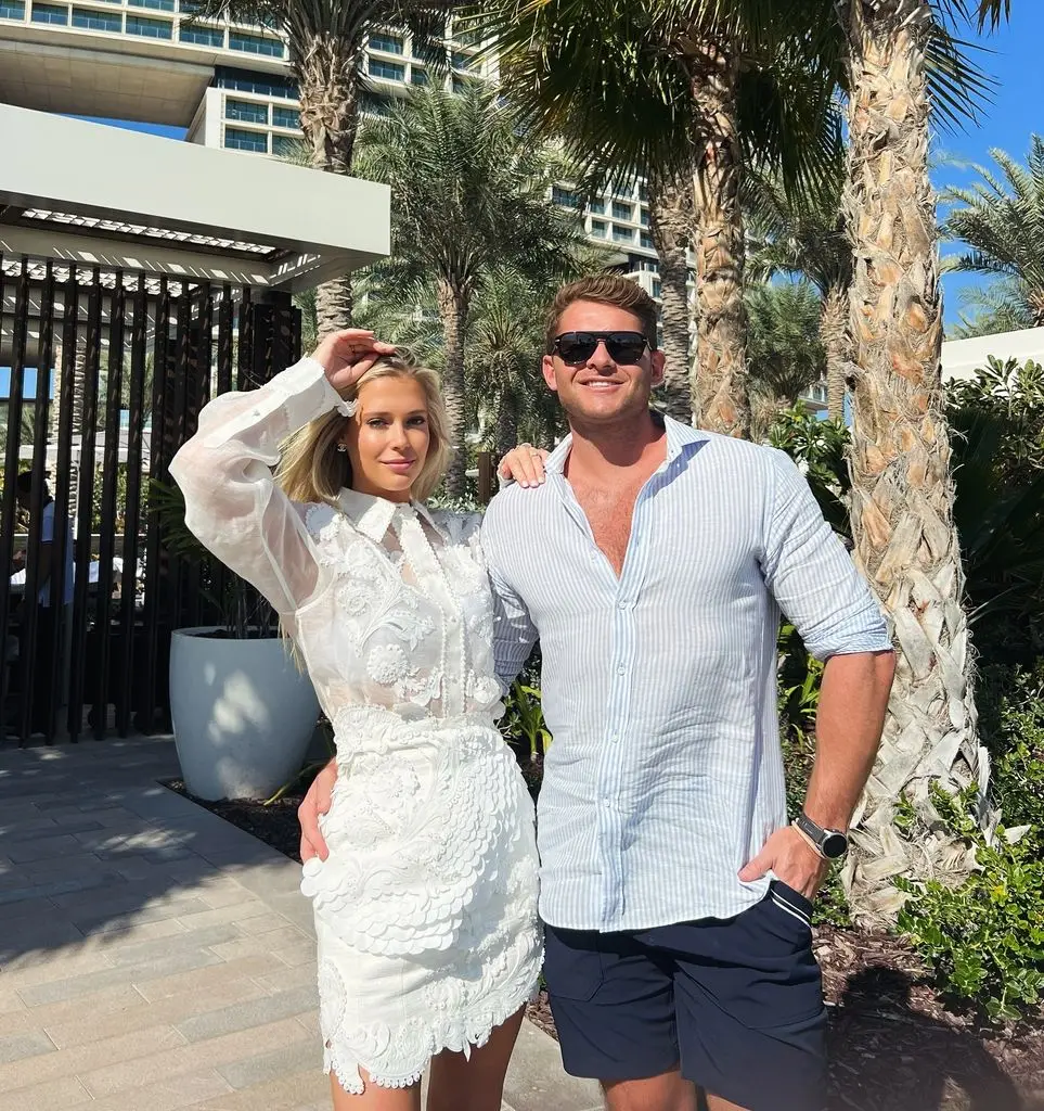 Amelia Spencer in white dress with Greg Mallett on holiday