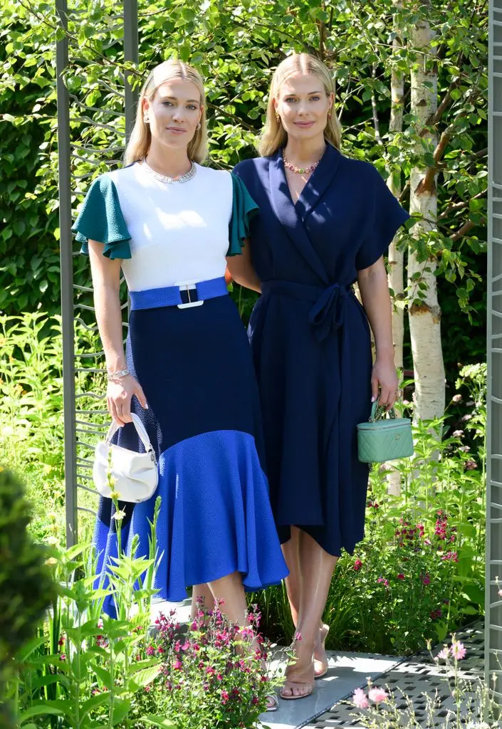 The Spencer twins in swishy dresses against leafy backdrop