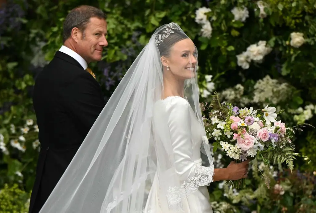 Olivia wore the Faberge Myrtle Leaf Tiara made for Grosvenor brides to wear on their wedding day, which has been in the family since 1906. Her bouquet was made of flowers picked from the gardens of the duke’s family home, Eaton Hall.